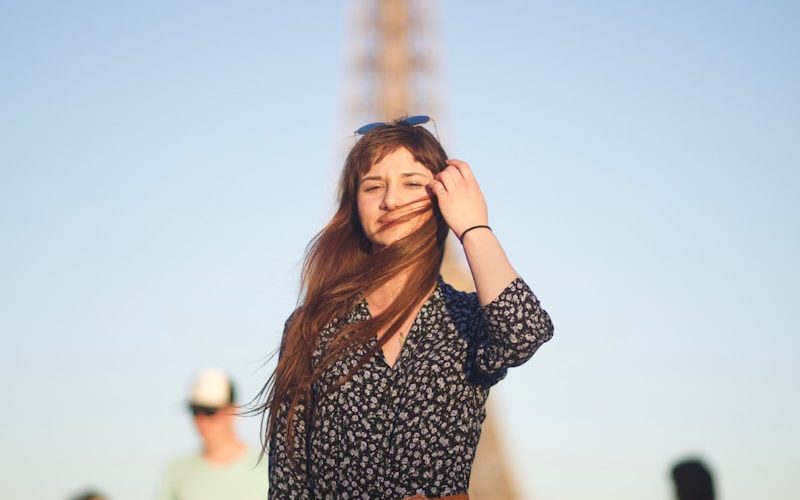 a woman standing in front of the eiffel tower